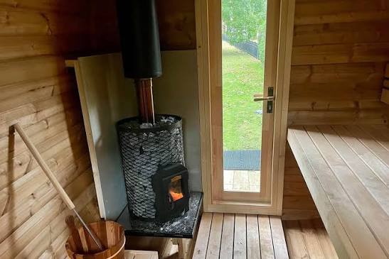Wood-fired sauna stove, bucket, ladle and bench
