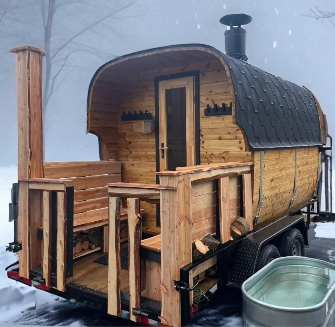 Peak Heat wood-fired mobile sauna with the included cold plunge in the snow